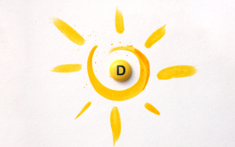 Gelbe Malerei eines Sonnenmotivs mit einer runden, gelben Pille mit dem Buchstaben D in der Mitte.